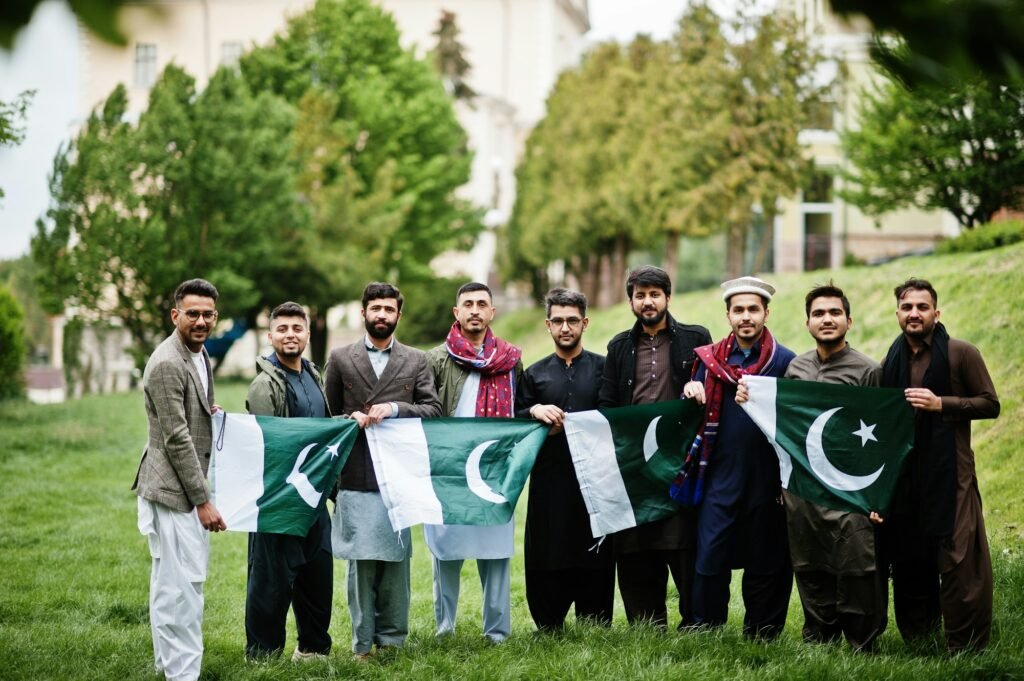 Group of pakistani man wearing traditional clothes salwar kameez or kurta with Pakistan flags.